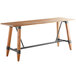 A Lancaster Table & Seating wooden bar height table with live edge and legs.