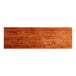 A long, rectangular solid wood table top with a rustic mahogany finish.