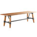 A Lancaster Table & Seating solid wood live edge dining table with legs.