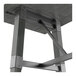A bar height table with a solid wood live edge top and an industrial metal trestle base in a slate gray finish.