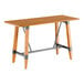 A Lancaster Table & Seating wooden table with a live edge top and trestle base.