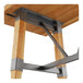 A Lancaster Table & Seating bar height buffet table with a metal trestle base and wood top with live edges.