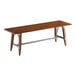 A rectangular solid wood table with a rustic walnut finish and a metal trestle base.