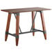 A Lancaster Table & Seating bar height table with a live edge wooden top and metal trestle legs.