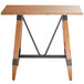 A Lancaster Table & Seating wooden table with metal legs.