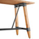 A Lancaster Table & Seating wooden table with metal legs.