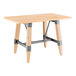 A Lancaster Table & Seating wooden table with a metal trestle base and bleached oak finish.