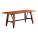 A Lancaster Table & Seating industrial wooden table with a trestle base.