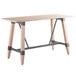 A Lancaster Table & Seating solid wood bar height trestle table with legs and a live edge.