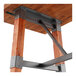 A Lancaster Table & Seating wooden table with metal trestle legs.