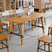 A Lancaster Table & Seating live edge wood table with chairs.