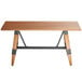 A Lancaster Table & Seating solid wood live edge dining table with metal legs.