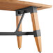 A Lancaster Table & Seating solid wood table with metal legs.