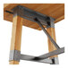A Lancaster Table & Seating wood table with metal trestle base.