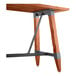 A Lancaster Table & Seating bar height table with a wooden top and metal trestle base.