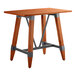 A Lancaster Table & Seating bar height table with a wooden top and trestle base.