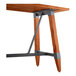 A Lancaster Table & Seating bar height table with a wooden top and metal trestle base.