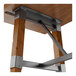 A Lancaster Table & Seating wooden table with metal trestle base legs.