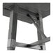 A Lancaster Table & Seating trestle base table with a metal frame and legs with a grey surface.