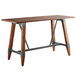 A Lancaster Table & Seating wooden table with metal legs.