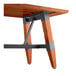 A Lancaster Table & Seating wooden table with a trestle base and a rustic mahogany finish.