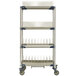 A MetroMax i mobile four tier tray and steam pan drying rack with drip tray on wheels.