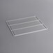 A white metal grid shelf for an Avantco Deli Case on a gray surface.