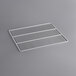 A white metal grate shelf for an Avantco deli case on a gray surface.