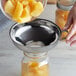 a glass jar with a lid filled with fruit