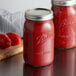 Two Ball wide mouth quart glass canning jars filled with tomato sauce on a table.