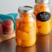 Two Ball quart canning jars filled with peaches.