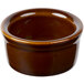 A brown ceramic bowl sitting on a table.