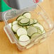 Sliced zucchini in a plastic container.