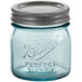 A blue Ball glass canning jar with a silver metal lid.