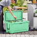 A man putting bottles into a CaterGator Seafoam cooler.