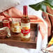 A table with food and a bottle of Torani Pumpkin Spice flavoring syrup on it.