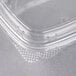 A clear plastic Genpak deli container with a clear high dome lid.