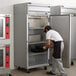 a red and black oven with knobs