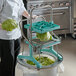 A woman using a Prince Castle Drum Ring to chop lettuce.