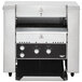 A stainless steel Vollrath conveyor toaster on a black counter with black and white dials.