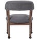 A Boss slate gray linen captain's chair with wheels.