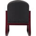 The back of a Boss black fabric side chair with mahogany wood frame.