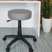 A gray Boss Office stool with wheels.