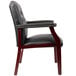 A black leather Boss Ivy League guest chair with mahogany wooden legs.