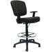 A Boss black drafting stool with a chrome base and adjustable arms.