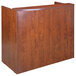 A cherry laminate reception desk shell with a wooden finish.