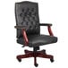 A Boss black leather office chair with mahogany legs.