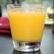 a close up of a glass of orange juice