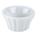 A white flared ramekin with wavy edges.