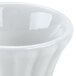 A close up of a white flared Hall China ramekin with a small rim.